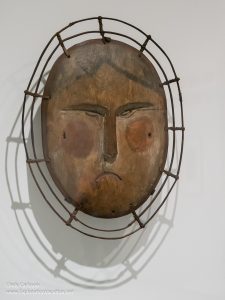 Carved and painted wooden mask of a woman's face