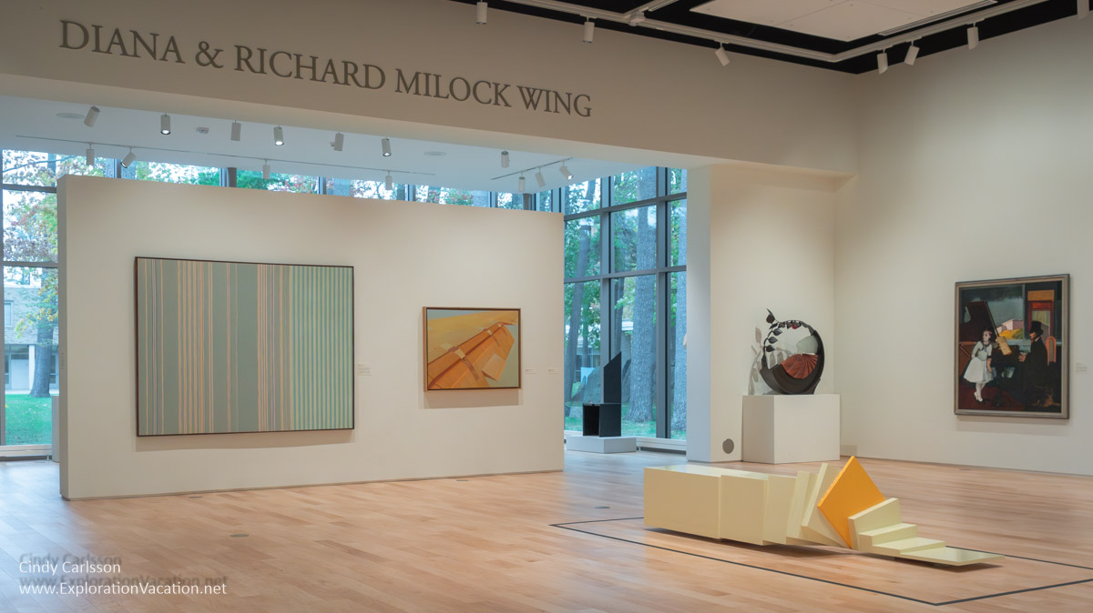 Photo of a gallery with “Yellow Rollover” by David Bar at the Dennos Museum Center in Traverse City, Michigan in 2018 © Cindy Carlsson at ExplorationVacation.net