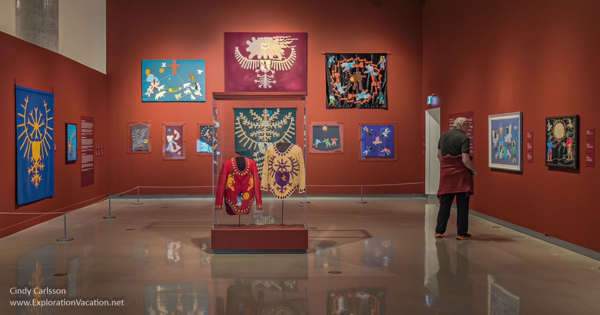 Photo of embroidered textiles by Normee Ekoomiak in a gallery at the Ottawa Art Gallery.
