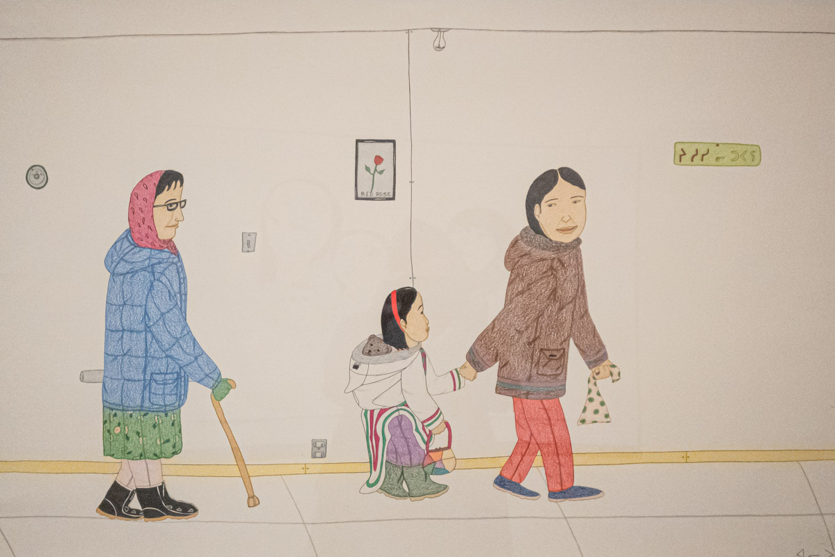 Photo of a drawing by Annie Pootoogook, THREE GENERATIONS, 2004-05. Colored pencil, graphite, and felt-tip pen on paper. Displayed at the McMichael Gallery in Canada