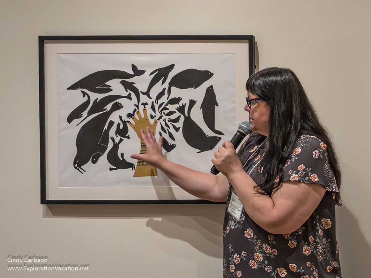 Photoe of Dorene Red Cloud with “Sedna’s Creations,”a print by Ningiukulu Teevee. at the Eiteljorg in Indianapolis, Indiana.