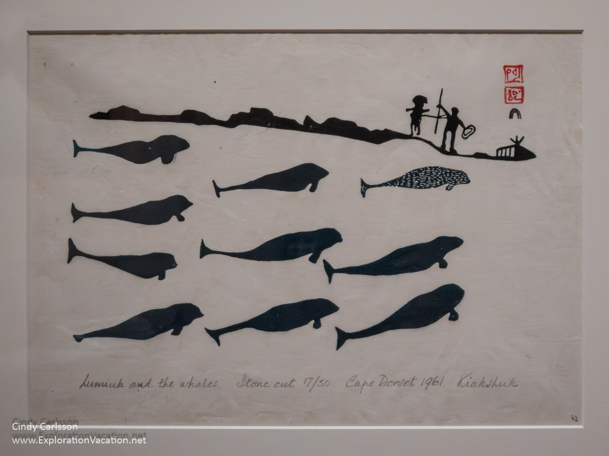 Photo of a print by Kiakshuk of people and whales at the Eiteljorg Museum in Indianapoilis.