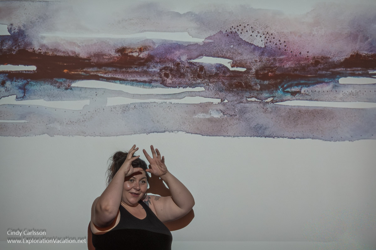 Artist Niap with one of her paintings.