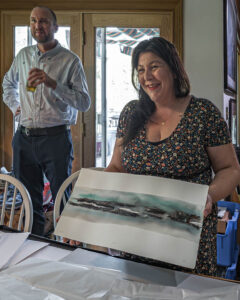 Inuit artist Niap showing off a painting of hers