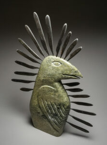Stone carving of a bird with a halo of baleen feathers by Arnaqu Ashevak