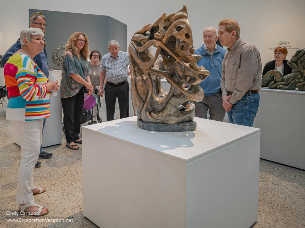 Abraham Anghik Ruben exhibit, Winnipeg Art Gallery A group of people looking at a soapstone sculpture by Abraham Anghik Ruben.
