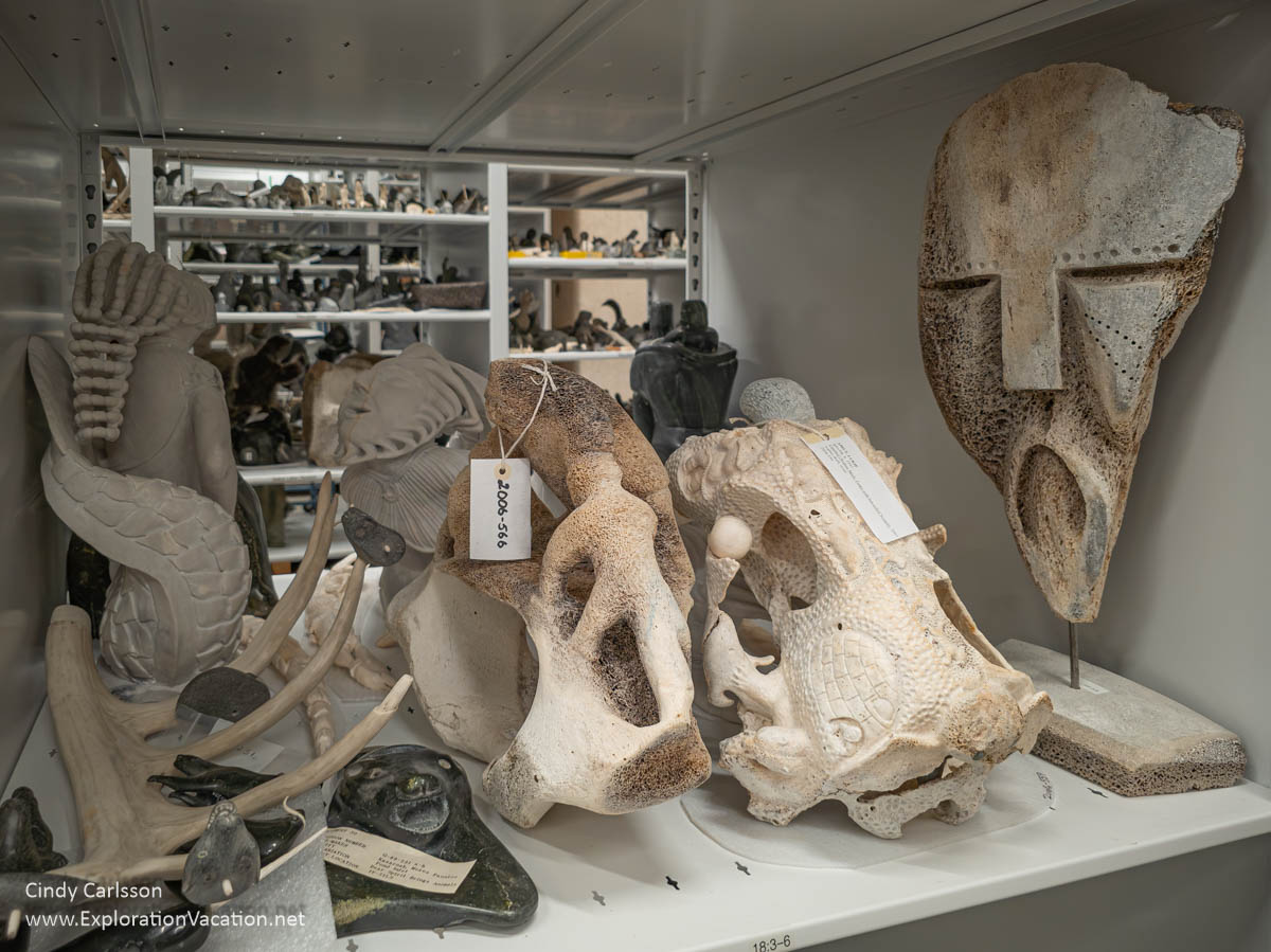 A shelf with whale bone sculptures with tags.