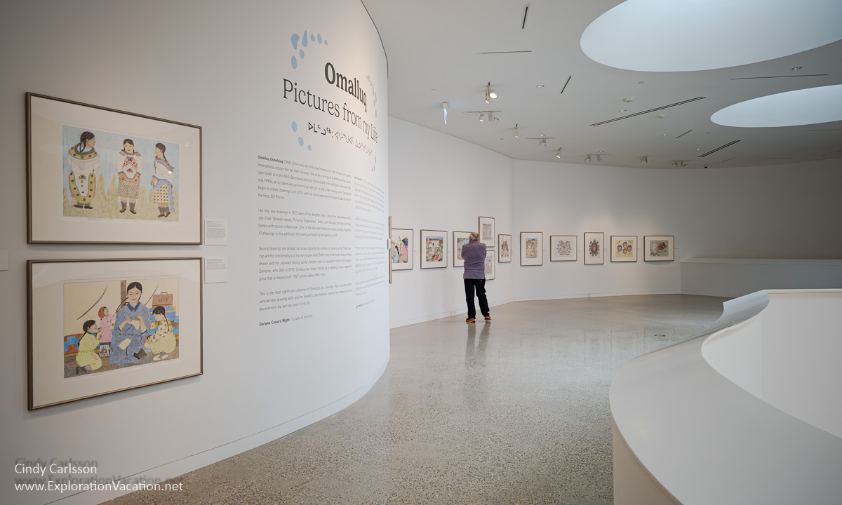 A long open gallery with drawings by Inuit artist Omalluq Oshutsiaq.